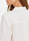 THE UPSIDE women's cream Hotel Du Cap Long Sleeve Shirt is made from tencel linen blend. The button up shirt features wide sleeve cuffs. Designed for layering and travel.