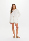 THE UPSIDE women's cream Hotel Du Cap Long Sleeve Shirt is made from tencel linen blend. The button up shirt features wide sleeve cuffs. Designed for layering and travel.