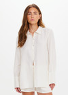THE UPSIDE women's cream Hotel Du Cap Long Sleeve Shirt is made from tencel linen blend. The button up shirt features wide sleeve cuffs. Designed for layering and travel.