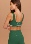 THE UPSIDE women's green Il Pelicano Scoop Bra is made from recycled rib. The scoop neck sports bra features removable cup. Designed for yoga and exercise.