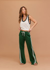 THE UPSIDE women's green When in Roma Holiday Pant is made from recycled fabric. The high waisted side stripe pant features splits at hem. Designed for comfort.