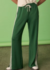 THE UPSIDE women's green When in Roma Holiday Pant is made from recycled fabric. The high waisted side stripe pant features splits at hem. Designed for comfort.