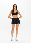 THE UPSIDE women's black Lucky Run Short features a elasticated waistband, a slightly curved hem, internal inner short for full coverage and invisble zip pockets. Made for running.