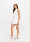 THE UPSIDE women's white Slam Pleated Tennis Dress features a quarter zip opening with mock neck, a pleated light-weight skirt with built-in inner short with pockets. Made for tennis.