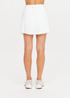 THE UPSIDE women's white Cadiz Pleated Skirt is made from a recycled lightweight fabric and features a drawcord on waist and built-in inner short with pockets. Made for tennis.