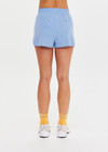 THE UPSIDE women’s blue recycled Era Short is designed to be mid rise, featuring a striped elastic drawcord and inner mesh brief in white. Made for running.