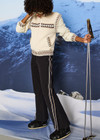 THE UPSIDE women’s black Hakuba Petra Zip Flare is a true-to-size fit and offers high water repellency, high breathability and bonded fleece underside for extra warmth. Designed for Après-ski and winter wear.