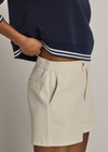 THE UPSIDE women’s cream cotton Penny Tilly Short is a low-rise style with a structured waistband and branded tortoiseshell button closure. Made for everyday wear.