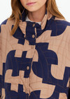 THE UPSIDE women’s organic cotton Mirage Carmen Quilted Jacket is an oversized fit and features a zip opening and pockets in our navy and tan geometric print. Made for lifestyle.