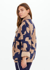 THE UPSIDE women’s organic cotton Mirage Carmen Quilted Jacket is an oversized fit and features a zip opening and pockets in our navy and tan geometric print. Made for lifestyle.