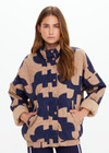 THE UPSIDE women’s organic cotton Mirage Carmen Quilted Jacket is an oversized fit and features a zip opening and pockets in our navy and tan geometric print. Made for lifestyle.