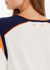 THE UPSIDE women’s cream cotton Elixir Seven Tee is designed for a relaxed fit and features orange and navy stripes on neckline and shoulders. Made for everyday wear.