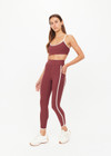 THE UPSIDE women’s red recycled peached Samara 25inch Legging is a soft & supportive fit and features side pockets and contrast cream stripes with curved hem detail. Made for pilates.