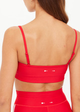 THE UPSIDE women's red eco tech Oxford Hutton Scoop Bra offers support and comfort with cream side stripes, adjustable straps, removable cups, and shelf bra. Made for high impact.
