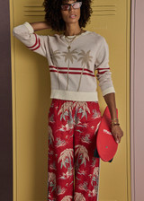 THE UPSIDE women's creme organic cotton Palma Joni Knit Crew features raglan sleeves, palm tree chest design, and red stripes around back and sleeves. Made for lifestyle.