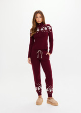 THE UPSIDE women’s maroon organic cotton Le Ski Jojo Knit Jogger features a soft knitted waistband with braided tassel drawcord, side pockets and snowflake design at ankles. Designed for Après-ski and winter wear.