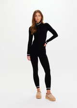 THE UPSIDE women’s black merino Wool Seamless Base Quarter Zip offers a soft & comfortable fit and features white striped ribbing on cuffs and collar. Designed for Après-ski and winter wear.