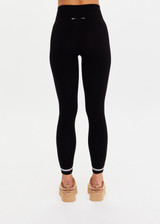 THE UPSIDE women’s black merino Wool Seamless 25inch Legging offers a soft & comfortable fit and features white striped ribbing on cuffs. Designed for Après-ski and winter wear.