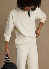 THE UPSIDE women’s creme cotton Hamsa Sunday Long Sleeve features a relaxed fit, dropped shoulders, and an embroidered evil eye on the sleeve. Perfect for layering.