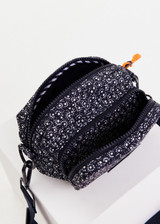 THE UPSIDE women’s navy recycled fabric Starlet Voyage Crossbody Bag features multi pockets with paracord zip pullers in our starlet ditsy print.