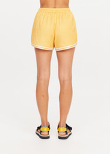 THE UPSIDE women's yellow Klio Short is designed for a mid-rise, relaxed fit and features a soft elasticated waistband with drawcord and contrast binds in cream along curved hem. Made for everyday.