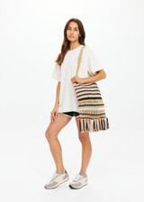 THE UPSIDE women's stripe Bohemia Kelly Crochet Bag is an organic hand-crochet tote with knotted tassel details and wooden beads. Made for lifestyle.