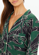 THE UPSIDE women's floral Tamara Rio Collared Shirt is a true-to-size fit featuring a green palm print, pearlised shell buttons and contrast cream piping. Made for lifestyle.