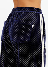 THE UPSIDE women's navy polka dot Spellbound Roma Pant is true to size and features metallic silver spots on velvet fabrication and side seam pockets. Made for lifestyle.