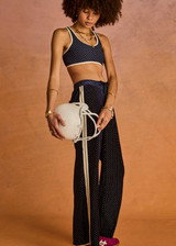 THE UPSIDE women's navy polka dot Spellbound Roma Pant is true to size and features metallic silver spots on velvet fabrication and side seam pockets. Made for lifestyle.