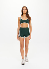 THE UPSIDE women's green Santa Fe 3.5inch Spin Short is soft, supportive with cream side seam and hem bindings, and side pockets. Made for yoga & pilates.