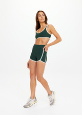 THE UPSIDE women's green Santa Fe 3.5inch Spin Short is soft, supportive with cream side seam and hem bindings, and side pockets. Made for yoga & pilates.