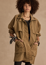 THE UPSIDE women's brown Rylan Anorak is relaxed fit, mid-length, made from tan wrinkled water-resistant fabric. Made for yoga & pilates.