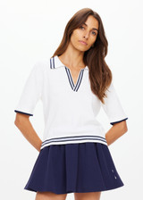 THE UPSIDE women's white tennis, pickleball & padel Archie Collared Knit Polo is made from organic cotton and features navy & dusty blue striped ribbing at front placket, collar and hem.