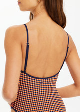 THE UPSIDE women's orange and navy check Solaris Flow One Piece features a scoop front neckline and low back with adjustable straps. Designed for swim.