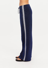 THE UPSIDE women's navy Galaxia Loretta Pant is designed for a mid to low rise fit and features elasticated waistband, drawcord with side seam pockets and knitted tape down sides. Made for lifestyle.