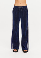 THE UPSIDE women's navy Galaxia Loretta Pant is designed for a mid to low rise fit and features elasticated waistband, drawcord with side seam pockets and knitted tape down sides. Made for lifestyle.