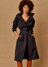 THE UPSIDE women's black James Hooded Trench Coat is a waterproof long line coat and features a fold-a-way hood, magnetic snap closures, an adjustable waist belt and external pockets. The perfect everyday coat.