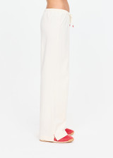 THE UPSIDE women's cream cotton Noosa Calling Track Pant is a low-rise straight leg pant with a soft elastic waistband, made from soft brushed recycled fabric. Made for lifestyle.