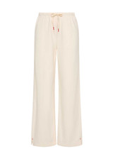 THE UPSIDE women's cream cotton Noosa Calling Track Pant is a low-rise straight leg pant with a soft elastic waistband, made from soft brushed recycled fabric. Made for lifestyle.