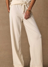 THE UPSIDE women's cream cotton Noosa Calling Track Pant is a low-rise straight leg pant with a soft elastic waistband, made from soft brushed recycled fabric. Made for lifestyle.