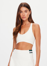 THE UPSIDE women's cream recycled soft peached Courtship Jetta Racerback Bra features a V neckline with removable cups and an elasticated underbust for support. Made for tennis, golf & pickleball.