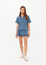 THE UPSIDE women's navy and blue plaid cotton Clubhouse Dom Polo Shirt is a relaxed fit and features a knitted collar with cream crochet detailing on edge. Made for tennis, golf & pickleball.