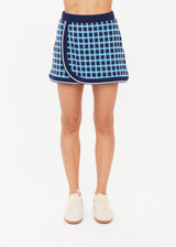 THE UPSIDE women's navy and blue plaid cotton Clubhouse Reece Mini Skirt is designed as a faux wrap skirt featuring a soft elastic waistband and a curved hemline. Made for tennis, golf & pickleball.