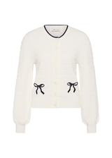THE UPSIDE women's cream Jolie Isabeli Knit Cardigan is a regular fit with a blouson sleeve crafted from a pointelle knit and features navy embroidered bows. Made for tennis, golf & pickleball.