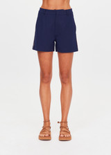 THE UPSIDE women's navy Toledo Leon Bermuda Short is a longerline tailored short featuring tan knitted tape down sides, flat waistband with belt loops and side pockets. Made for lifestyle.