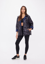 THE UPSIDE women's navy Levi Reversible Quilted Jacket is designed for a relaxed fit and features welt pockets, magnectic snap closure and a water resistant coating on black quilting. The perfect outerwear piece.