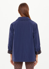 THE UPSIDE women's navy Levi Reversible Quilted Jacket is designed for a relaxed fit and features welt pockets, magnectic snap closure and a water resistant coating on black quilting. The perfect outerwear piece.