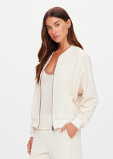 THE UPSIDE women's cream Navar Isabella Bomber Jacket is an oversized fit with raglan sleeves in our castilla "TU" design and features a front patch pocket, crafted from a knitted jacquard fabrication. Made for everyday wear.