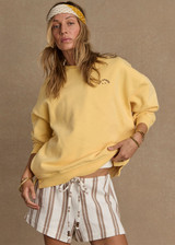 THE UPSIDE women's yellow organic cotton Paradise Coolum Crew is designed for an oversized fit, with discreet side seem pockets and ribbed neckline, cuffs and hem. Made for everyday wear.