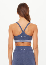 THE UPSIDE women's blue Bowery Baxter Tbar Sports Bra features a scooped neckline with ultraflex recycled fabrication, removeable bust cups and cream embroidered stripes at underbust. Made for yoga & pilates.